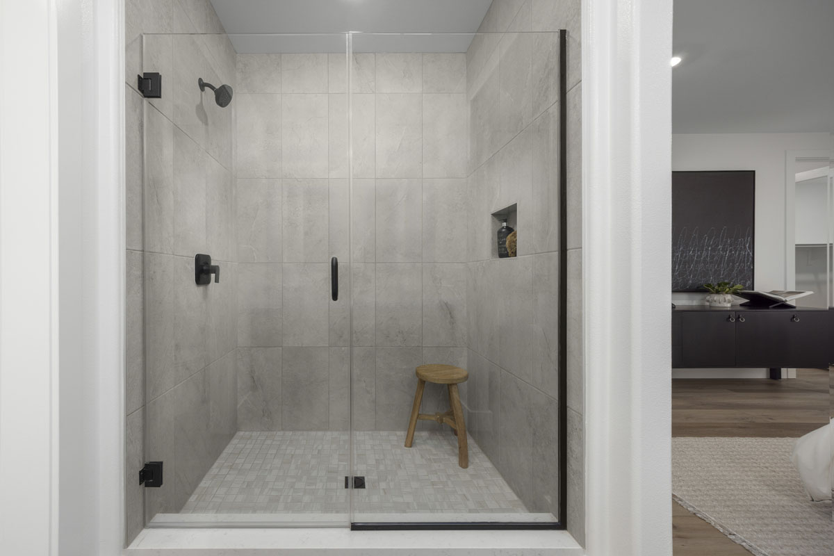 Walk-in shower with tile surround at primary bath