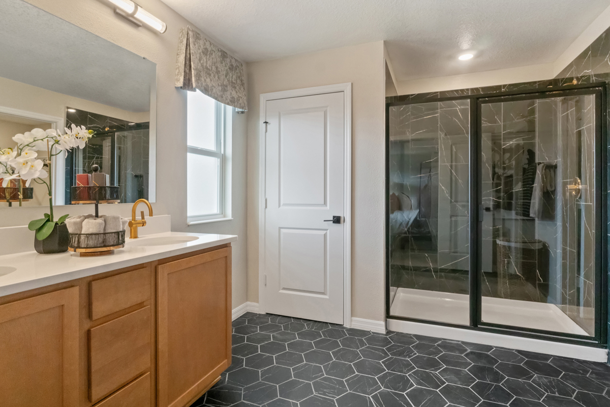 Walk-in shower with tile surround at primary bath