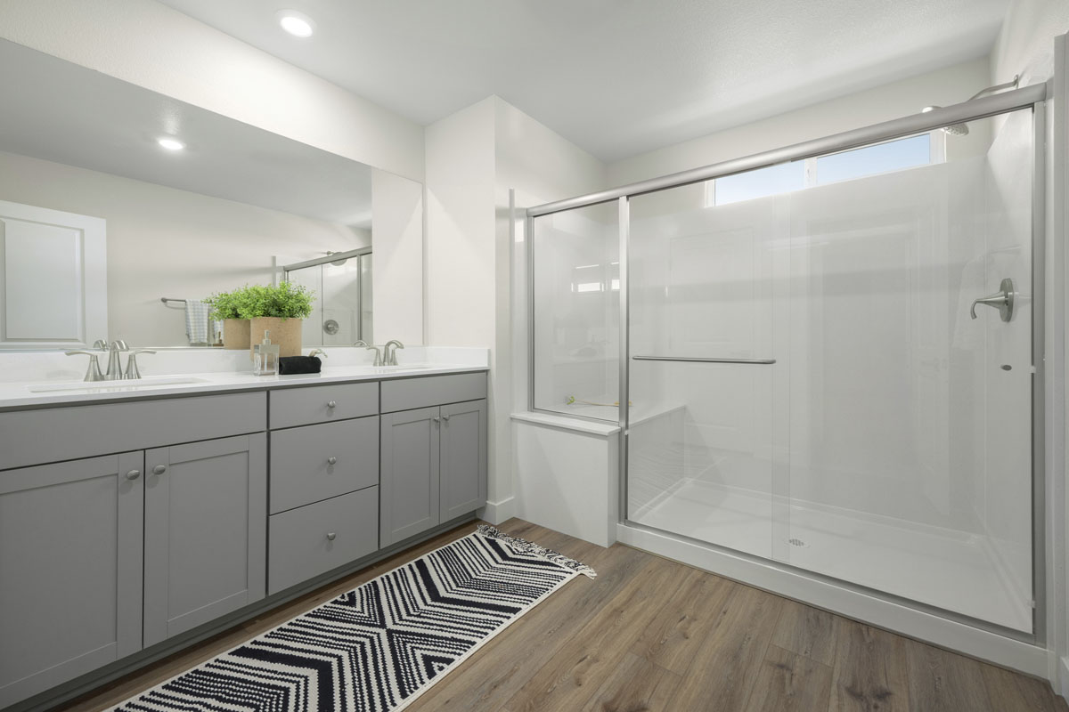 Enlarged walk-in shower with seat at primary bath